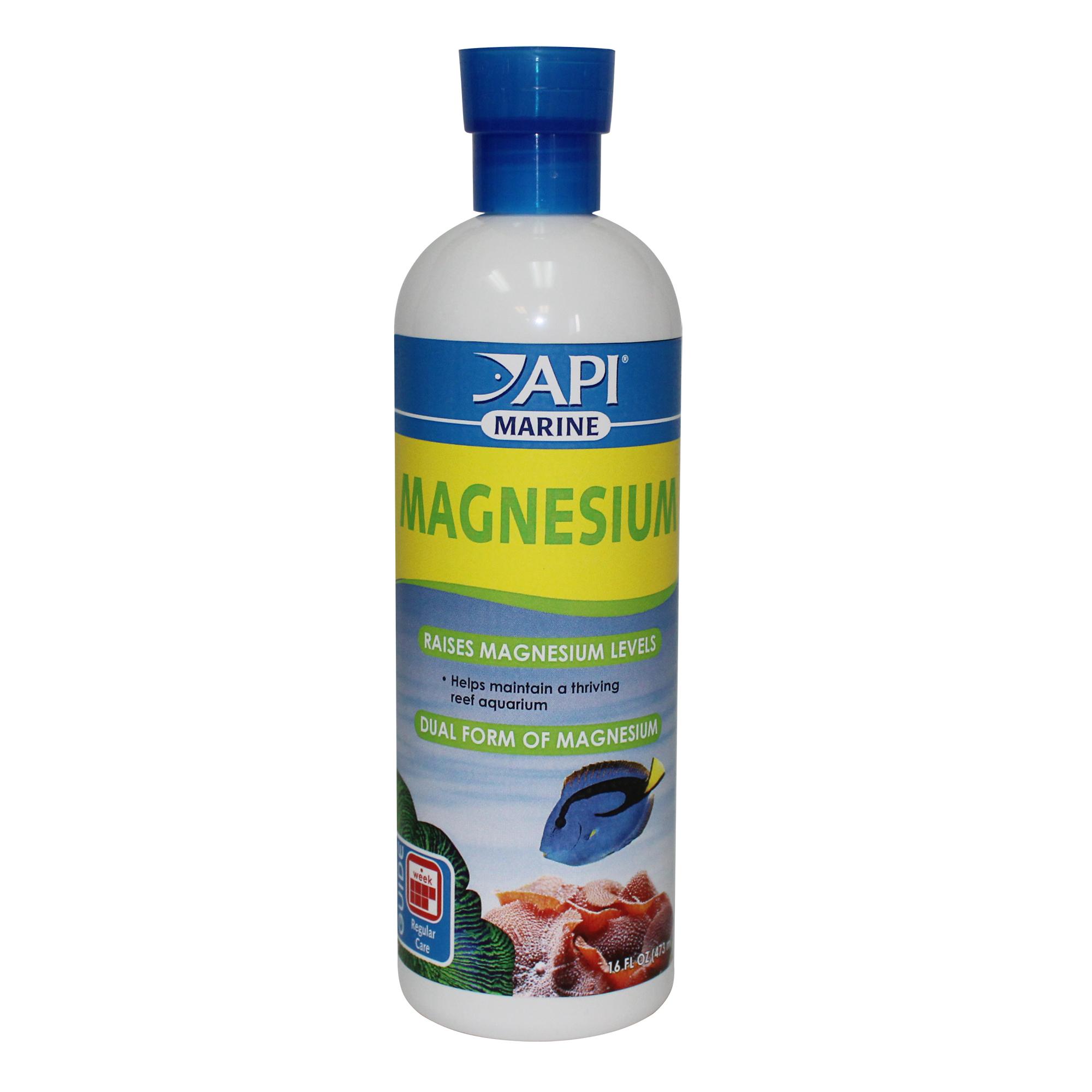 A bottle of API Marine Magnesium supplement for reef aquariums, featuring a blue cap, bold green lettering, and an image of a Blue Tang swimming over coral.